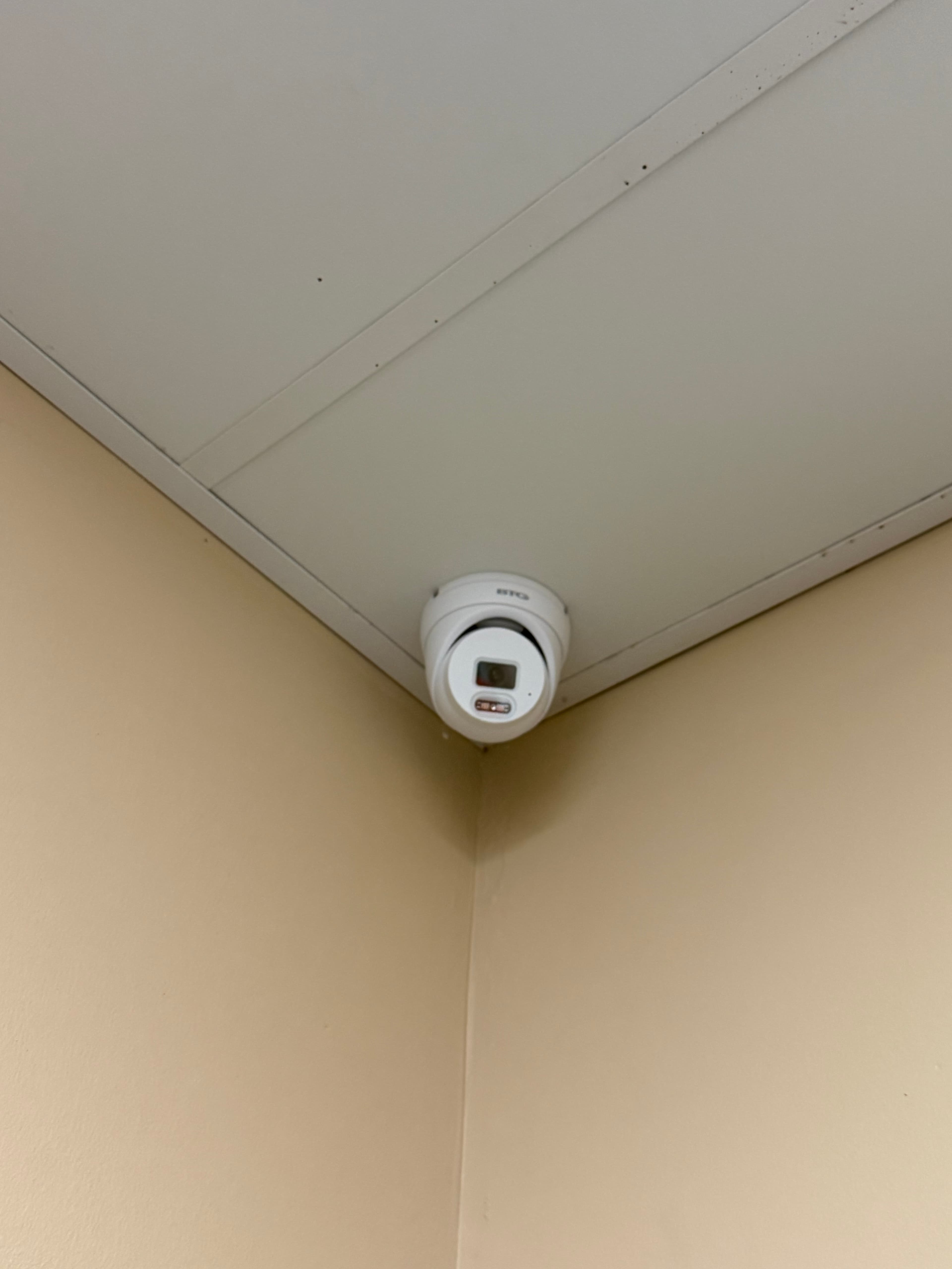 Dome security camera mounted on ceiling at Stacked & Tossed