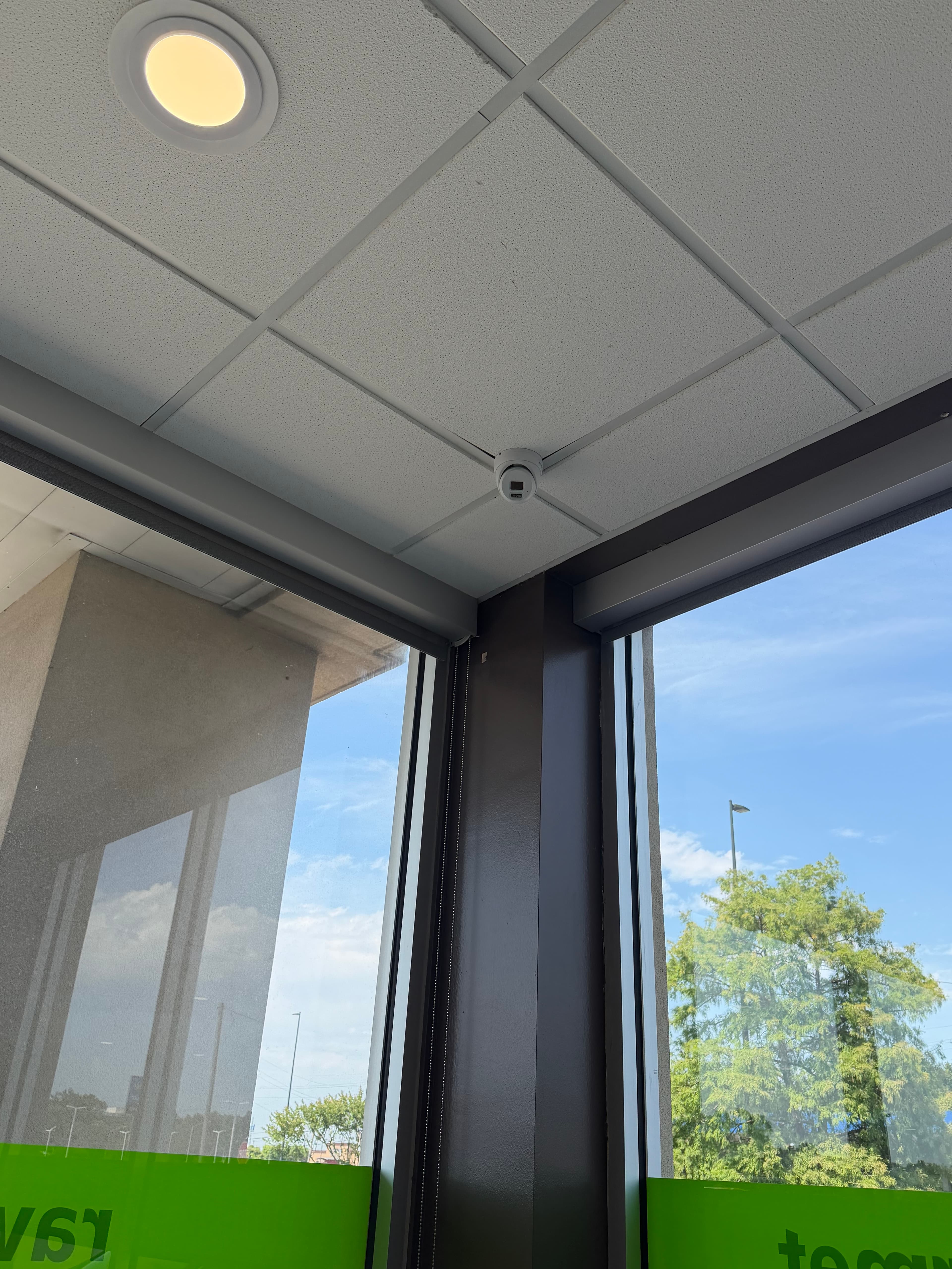 Corner-mounted CCTV camera overlooking windows and seating